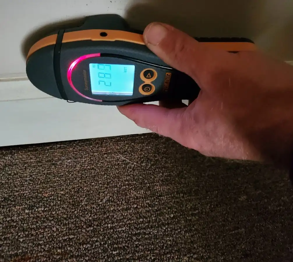 Moisture detection at baseboard during Storm Damage Restoration in New London